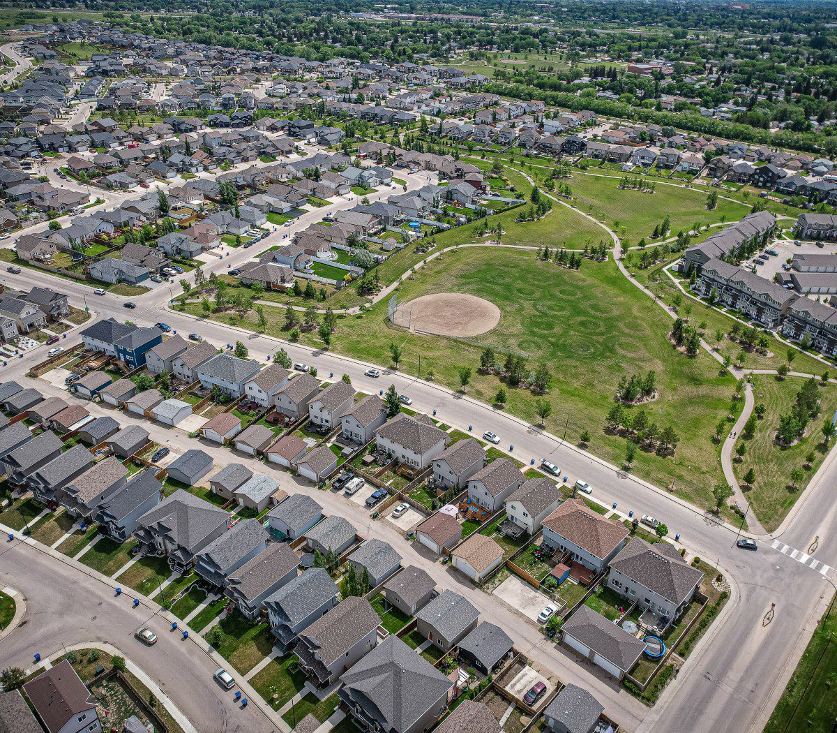 Aerial view of suburban neighborhood with park.
