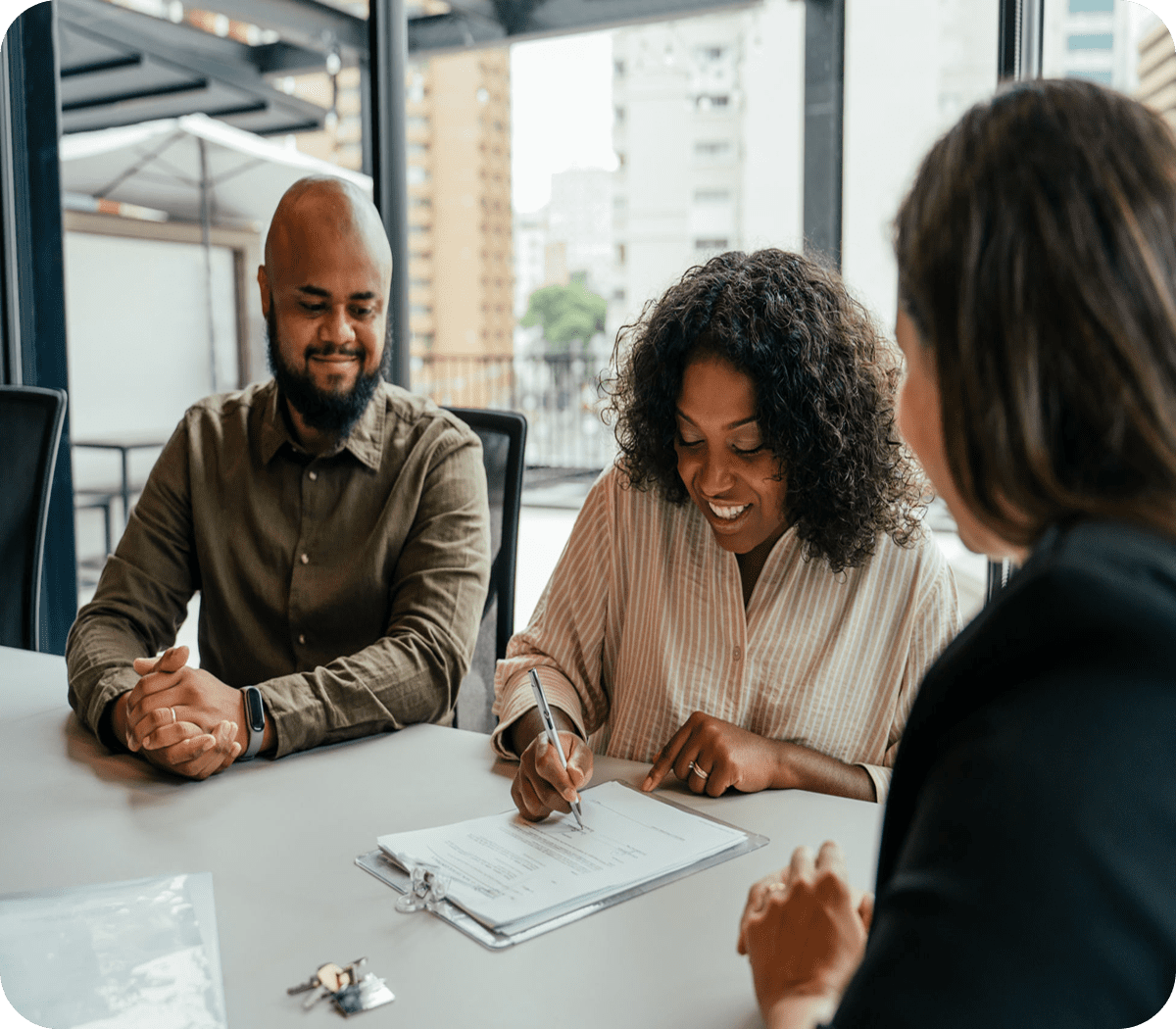 People signing documents at a table.