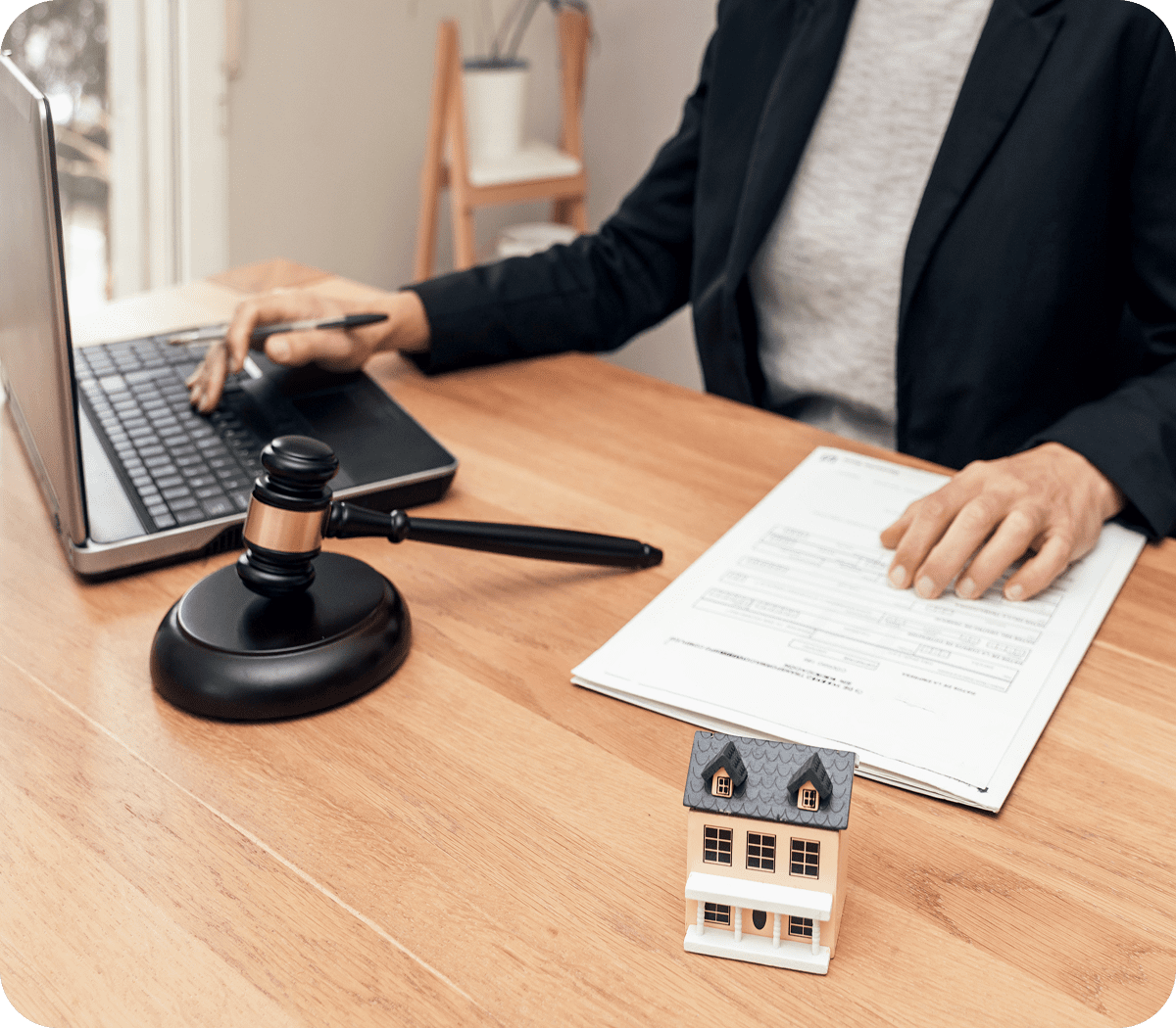 Person working on legal documents, gavel nearby.