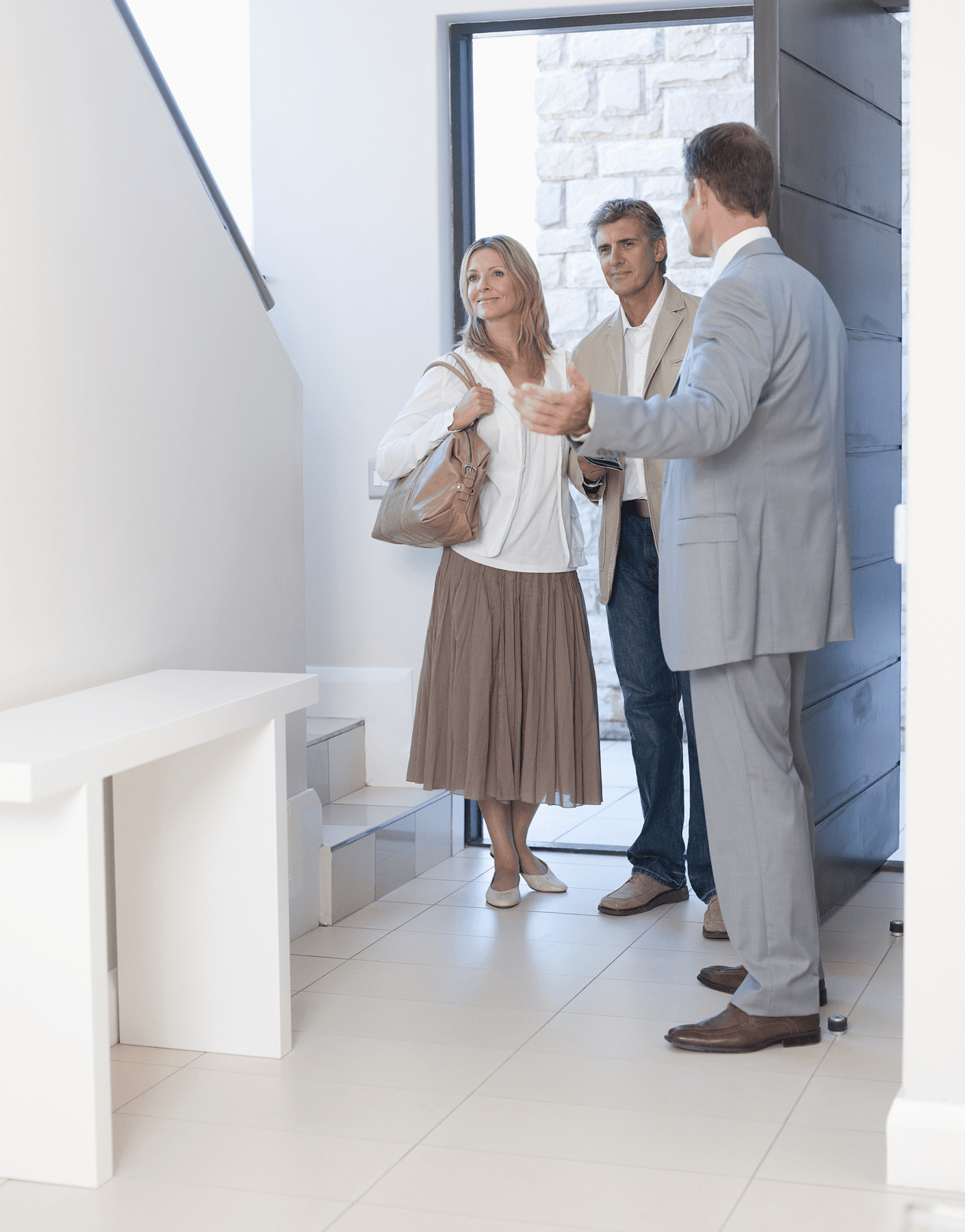 Real estate agent showing couple a house.
